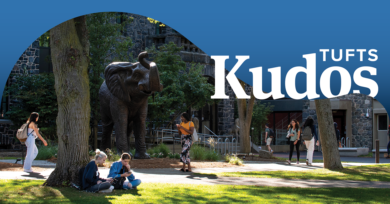 Students outside on campus near the Jumbo statue. Upper right corner has the words "Tufts Kudos" over a blue swath of color.