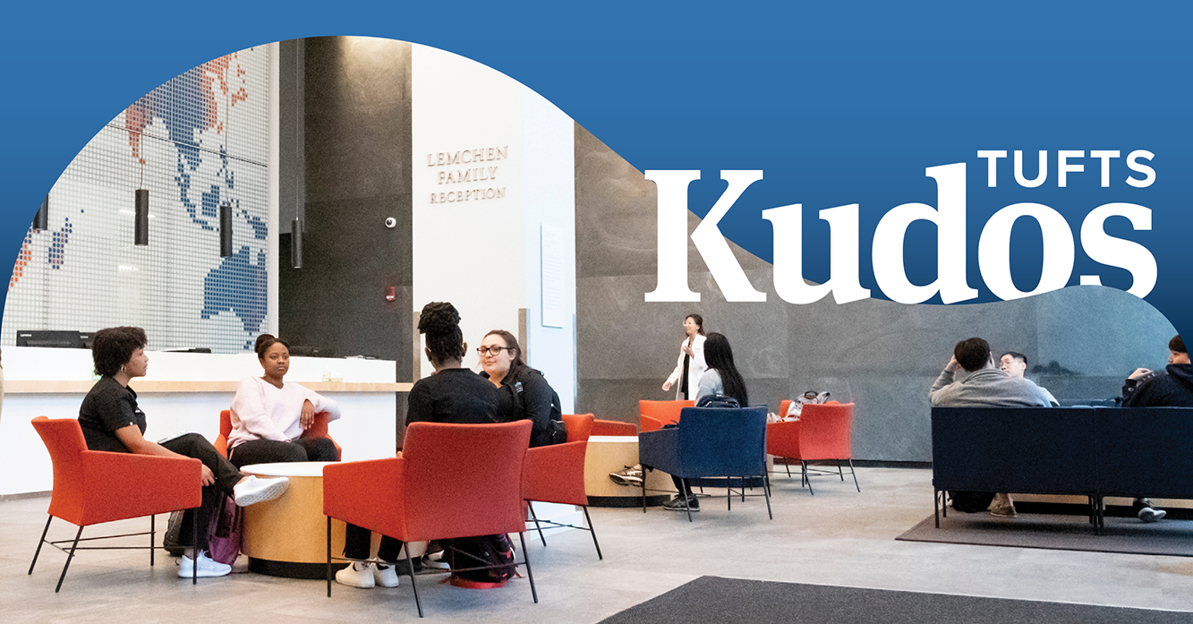 Students sitting and talking in the School of Dental Medicine lobby. The words "Tufts Kudos" appear over a blue banner of text in the upper right corner.