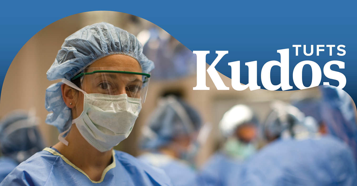 Student at the School of Medicine dressed in scrubs, a hairnet, face mask, and face shield. The words Tufts Kudos appear in white on a blue banner in the upper right corner.