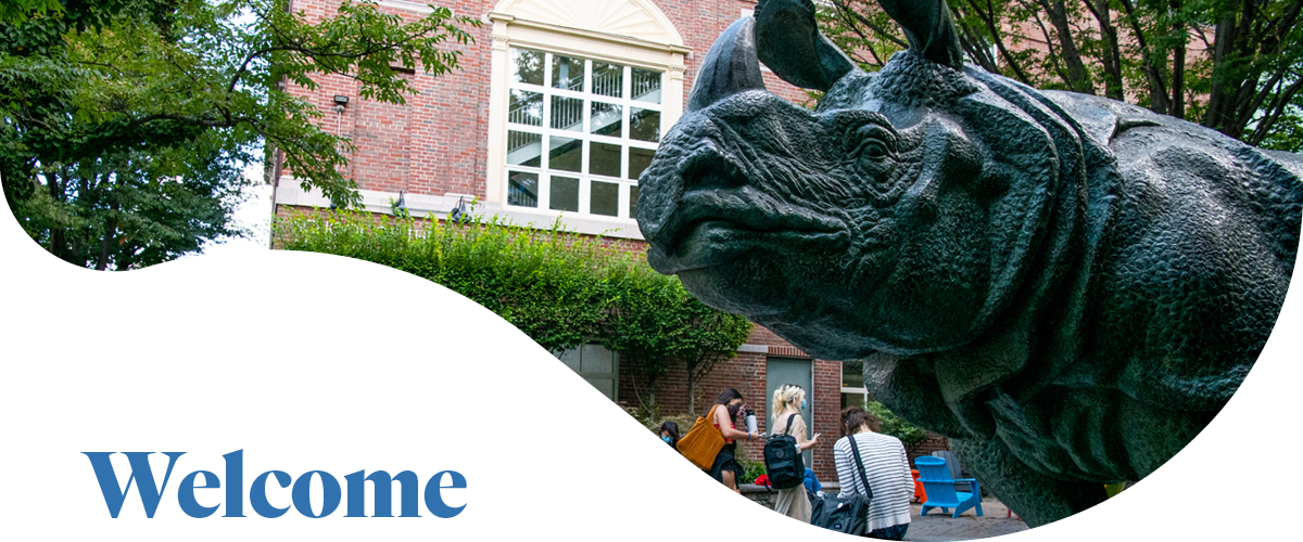 Bessie the Rhino statue foregrounded in front of the SMFA next to the word "Welcome"