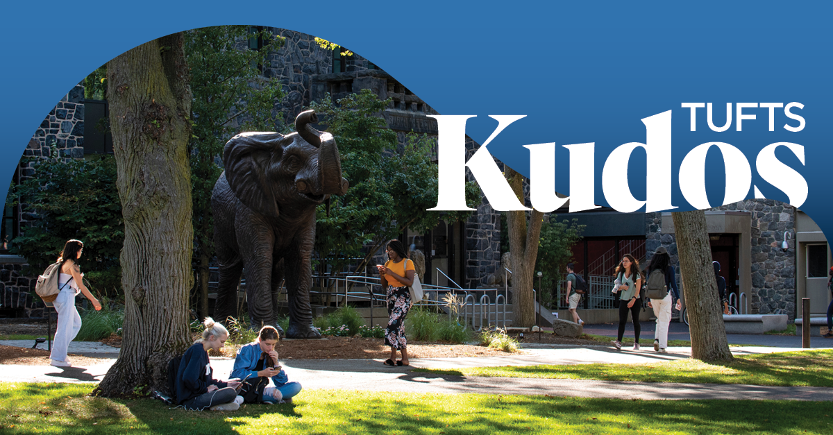 Students walking by the Jumbo the Elephant statue on the campus of Tufts University overlayed with the text "Tufts Kudos."